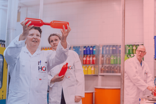 Holland Colours at Drinktec 2022 - page header - holding beverage bottles