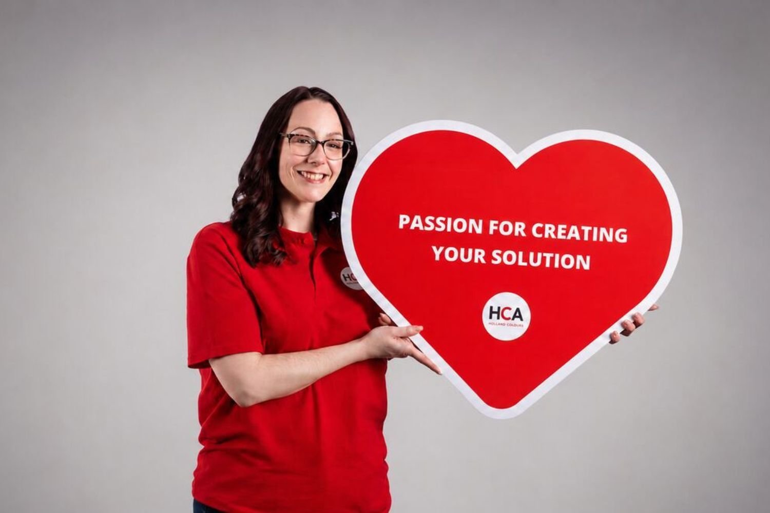 HCA Woman Holding Branded Heart in Gray Studio